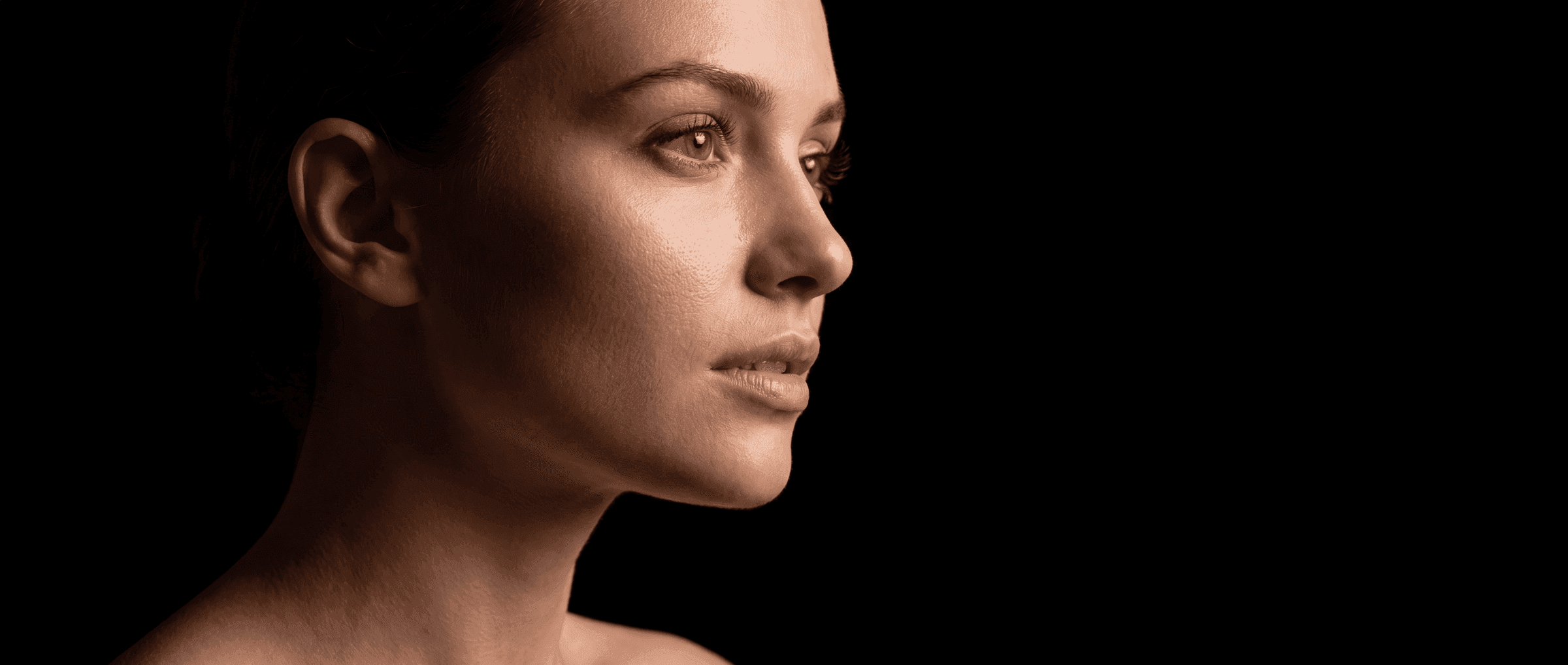 Cinematic profile portrait on a dark background